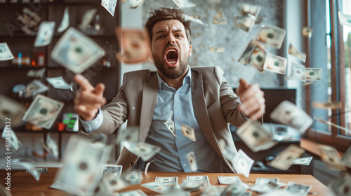 Excited businessman with money flying around him in an office