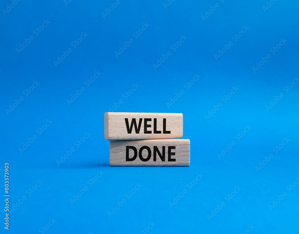 Well done symbol. Wooden blocks with words Well done. Beautiful blue background. Business and Well done concept. Copy space. Well done symbol. Wooden blocks with words Well done. Beautiful blue background. Business and Well done concept. Copy space.