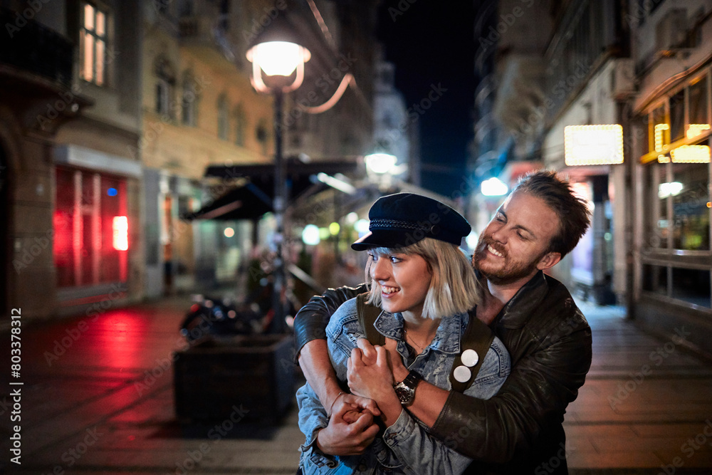 Loving couple enjoying a romantic evening stroll in the city Loving couple enjoying a romantic evening stroll in the city