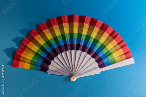 Beautiful multicolored fan on a blue background  heat  texture  colors