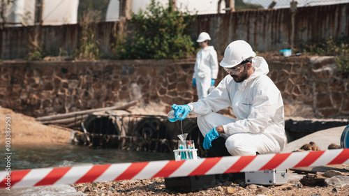 Scientists in protective suits conduct chemical and water quality analyses to monitor the factory s outputs  safeguarding against hazards and contamination.