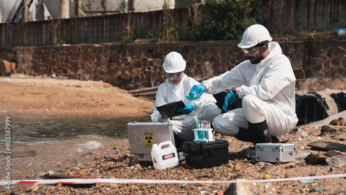 Scientists in protective suits conduct chemical and water quality analyses to monitor the factory's outputs, safeguarding against hazards and contamination.