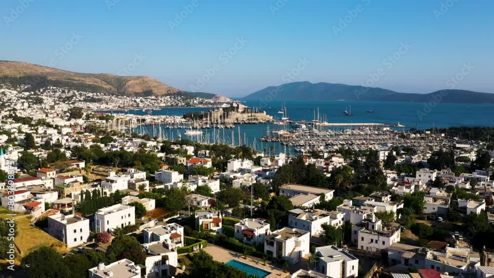 Bodrum city aerial shot. Aegean sea, traditional white houses, flowers, marina, sailing boats, yachts in Bodrum town Turkey. Bodrum city aerial shot. Aegean sea, traditional white houses, flowers, marina, sailing boats, yachts in Bodrum town Turkey.