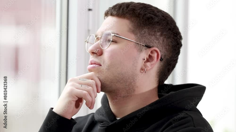 young man thinking looking out the window young man thinking looking out the window