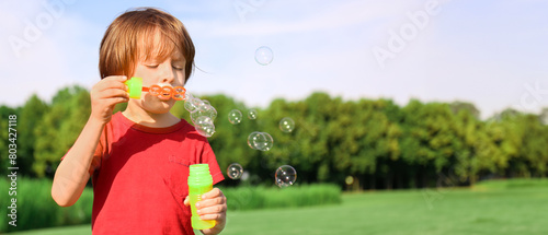 Cute little boy blowing bub...