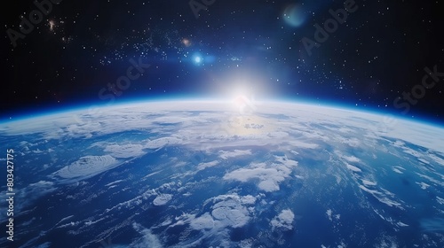 Stunning view of Earth from space with sun rising over horizon and stars in dark sky.