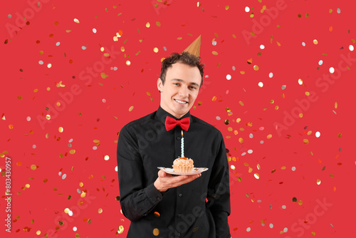 Young man with birthday cak...