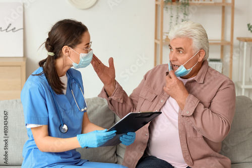 Senior man and nurse with c...