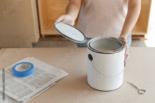 Taking paint can lid off. Opening paint can lid photo