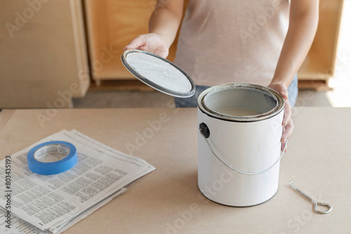 Taking paint can lid off. Opening paint can lid