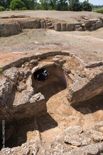 Italy Sardinia Alghero, Fertilia, tourists visit Prenuragic Necropolis Anghelu Ruiu 3200-2800 BC photo