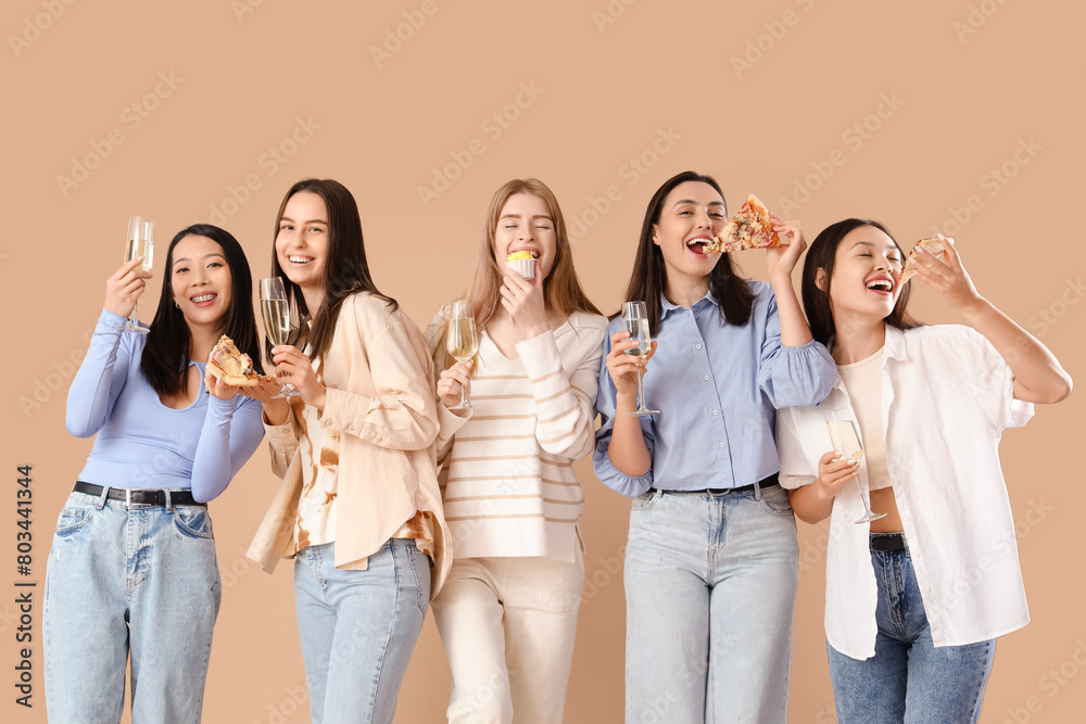 Group of young women with champagne and pizza on beige background. Hen Party Group of young women with champagne and pizza on beige background. Hen Party