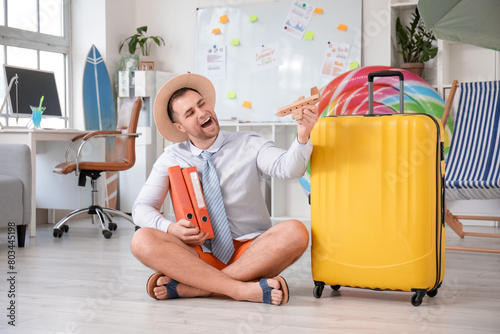 Happy male office worker wi...