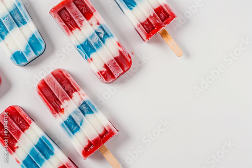 Flat lay of the icy popsicles with red, white and blue stripes like an American flag.