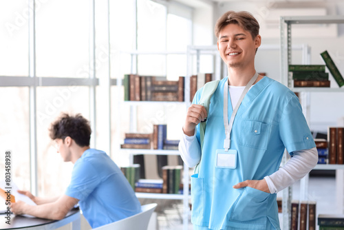 Male medical intern with backpack in library