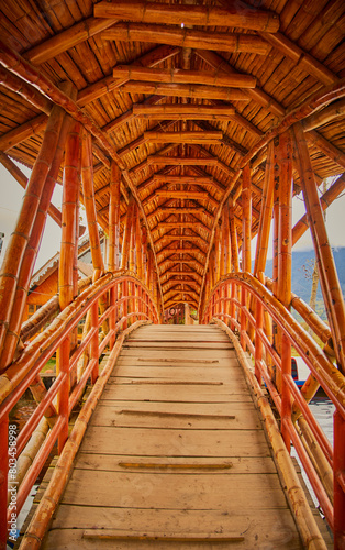 orange guadua bridge on the lake photo