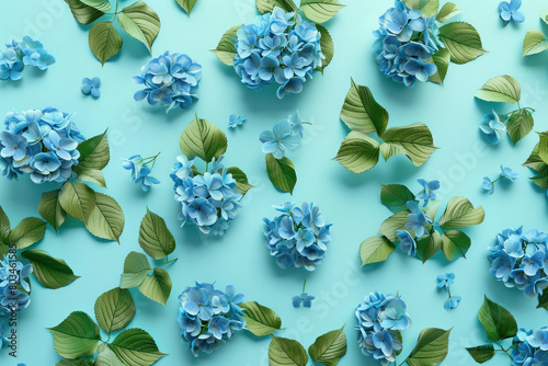 Blue hydrangea flowers and leaves on a light blue background beautiful top view flat lay floral arrangement photo