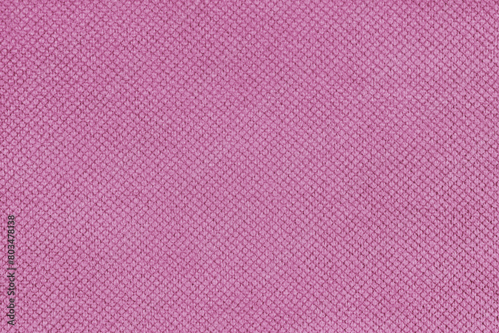 Plain pink velor upholstery fabric, jacquard with fine diamond texture background. Close up, macro cloth textile surface. Wallpaper, backdrop with copy space Plain pink velor upholstery fabric, jacquard with fine diamond texture background. Close up, macro cloth textile surface. Wallpaper, backdrop with copy space