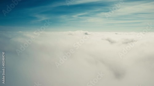 Flying down through moving clouds