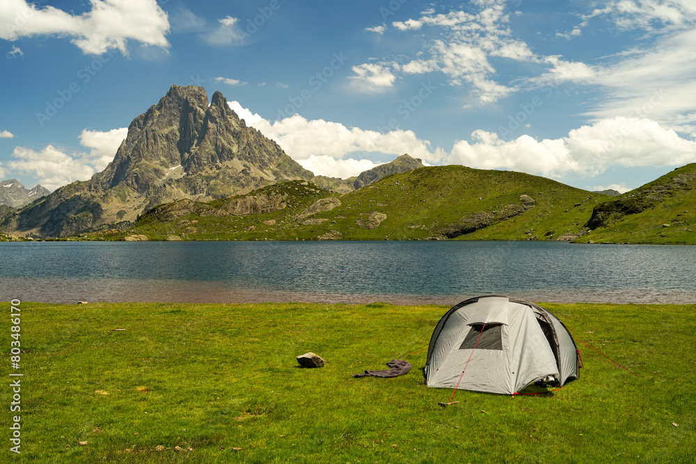 Tent near beautiful mountain lake in Pyrenees (Lacs d' Ayous), camping on popular hiking route, France
