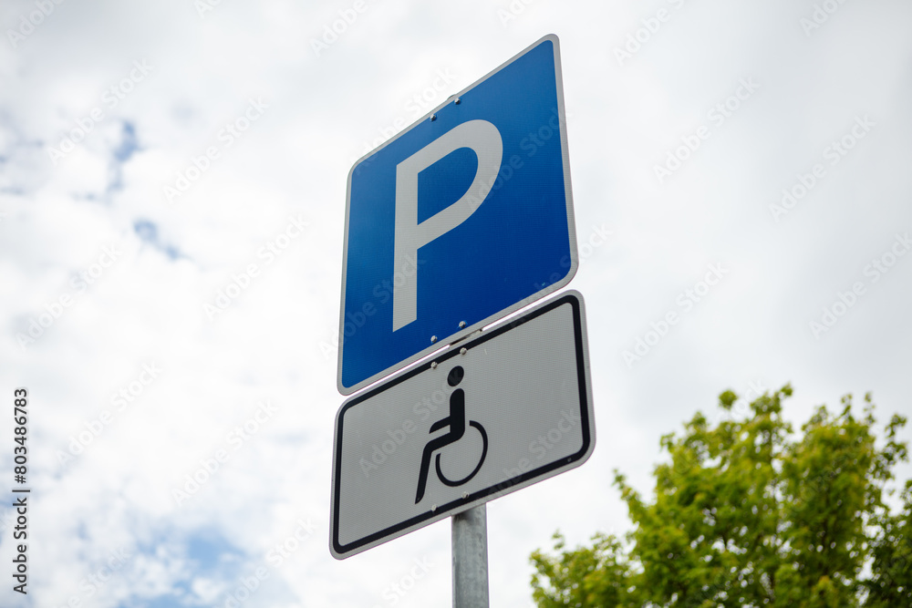 Parking sign for people with a disability. Summer day, clouds, blue sky, nobody.
Parking sign for people with a disability. Summer day, clouds, blue sky, nobody.