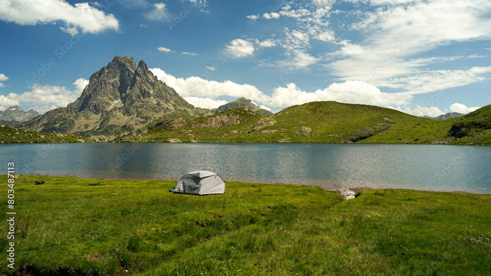 Tent near beautiful mountain lake in Pyrenees (Lacs d' Ayous), camping on popular hiking route, France
