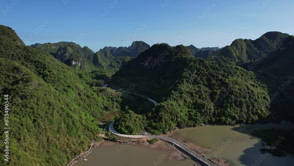Aerial view of water flowing through mountains and trees in a natural landscape 4K view Cat Ba Halong Bay Vietnam Asia Aerial view of water flowing through mountains and trees in a natural landscape 4K view Cat Ba Halong Bay Vietnam Asia