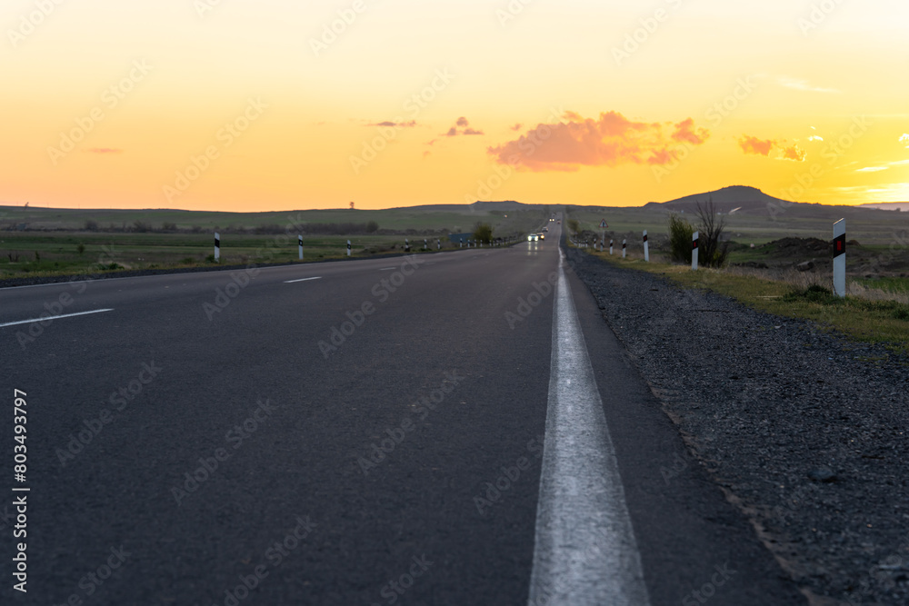 Asphalt road at sunset, travel concept