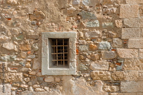 Old wall with a small window