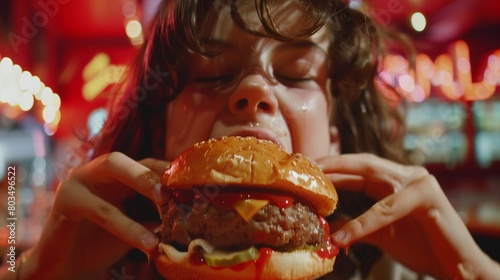 A teenager devouring a towering burger with gusto, their face smeared with ketchup and cheese.