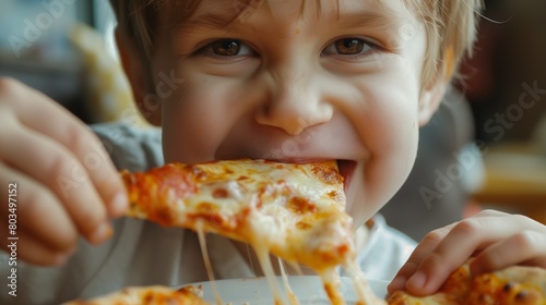 A child eagerly devouring a slice of pizza  with cheese stretching from the slice to their mouth in a deliciously gooey string.