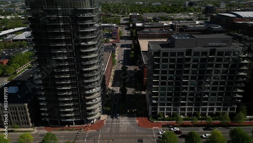 2024 aerial view of columbus ohio arena district in the morning overtop a roadway with a cinematic feeling modern office buildings brick structures