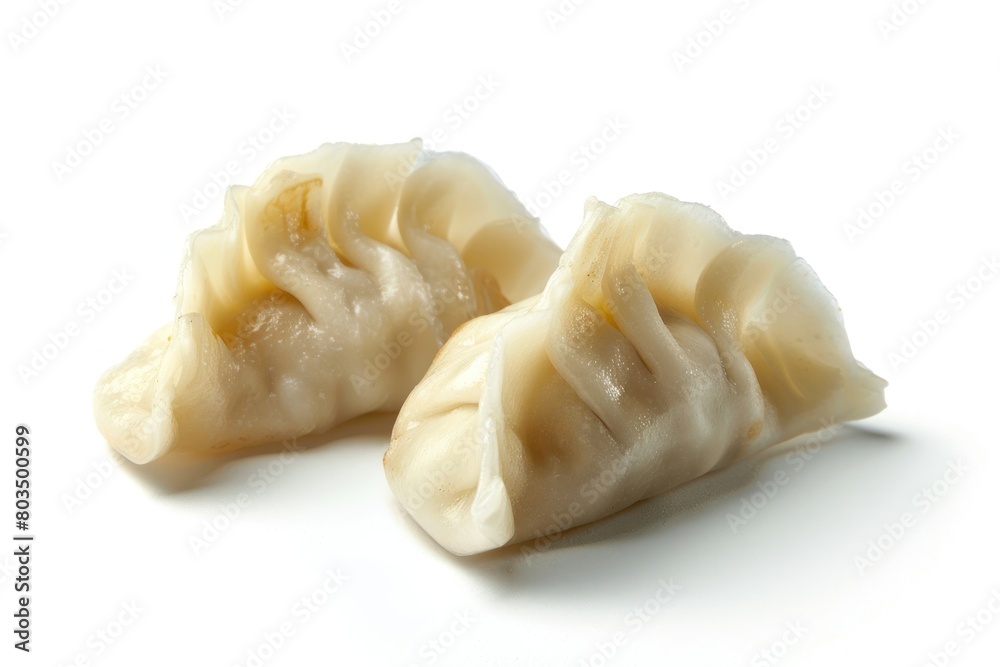 Two dumplings are sitting on a white background. The dumplings are white and have a spiral shape
