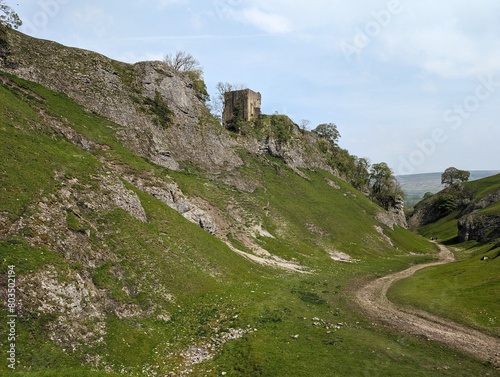 A view of Cave Dale, Derbyshire, UK, showing Peveril Castle on the hillside