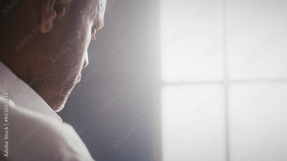 Muslim man in front of a window in the sunlight Muslim man in front of a window in the sunlight