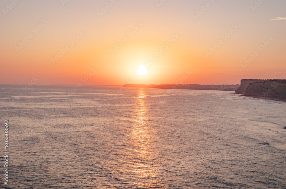 Tranquil sunset scenery at the ocean with the sunlight reflected on the water. Lagos, Portugal on October 10, 2023.