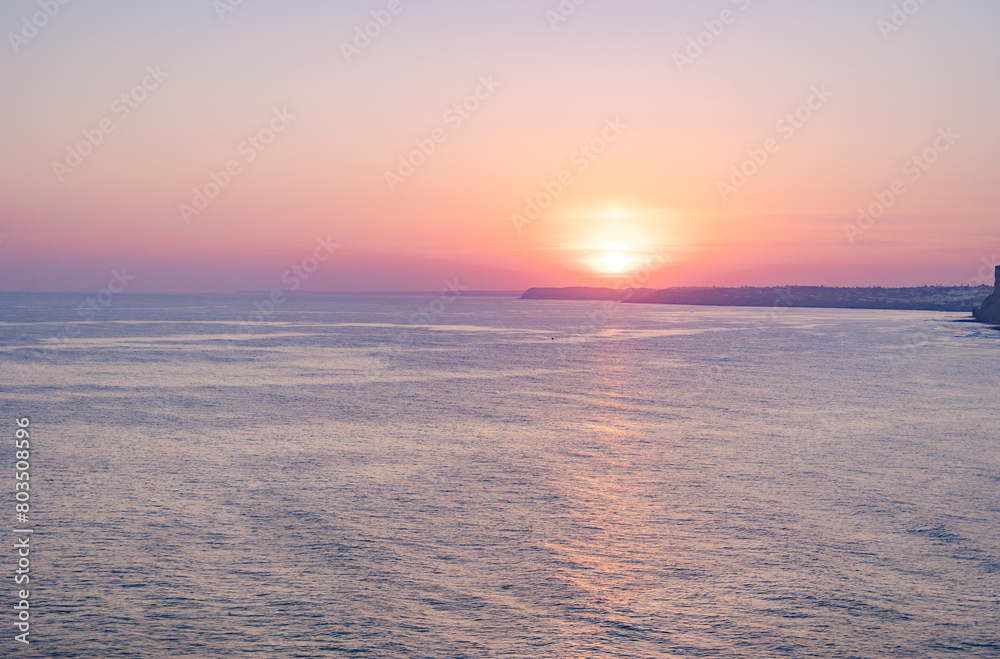 Tranquil sunset scenery at the ocean with the sunlight reflected on the water. Lagos, Portugal on October 10, 2023.