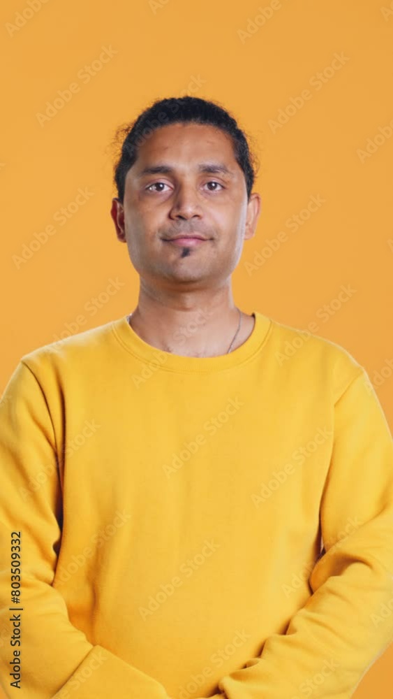Portrait of radiant optimistic indian man with positive facial expression smiling, looking pleased. Calm merry person crossing arms, feeling satisfied, studio backdrop, camera B Portrait of radiant optimistic indian man with positive facial expression smiling, looking pleased. Calm merry person crossing arms, feeling satisfied, studio backdrop, camera B
