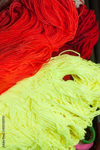 Two Balls of Red and Yellow Wool, Ready to be Crafted into Cozy Creations