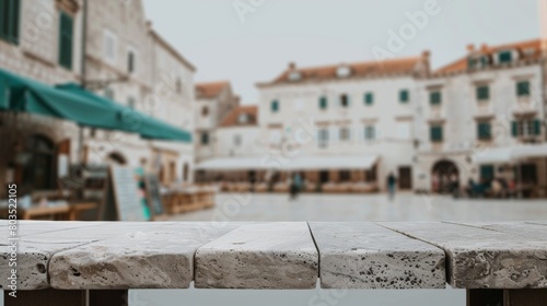 Elegant Stone Table with a Vibrant Historical Town Square Backdrop for Cultural Tourism photo