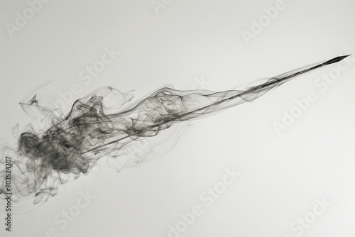 A javelin  its trajectory traced by a trail of smoke  frozen in time against a backdrop of white.