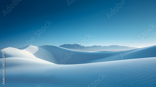 The contrast of a deep blue sky against towering white sand dunes, captured in the harsh light of midday © Muhammad