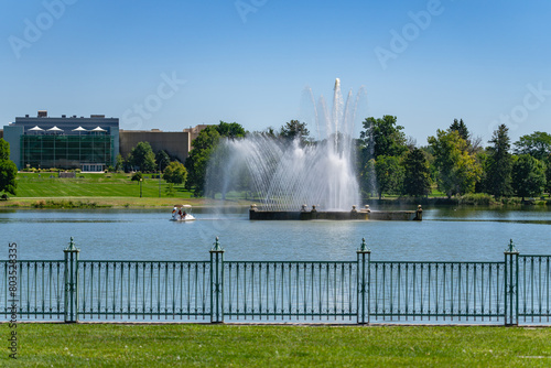 A beautiful Water Fountain at Denver's City Park shooting high jets of water into the air with the Denver Museum of Nature and Science building in the background.
