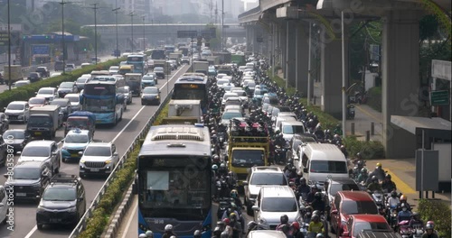Many vehicles pass by in heavy traffic