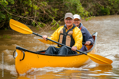Happy mature couple canoeing in lake. Tourists traveling activity during their active retirement