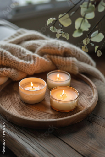Aromatic candles arranged on a wooden tray