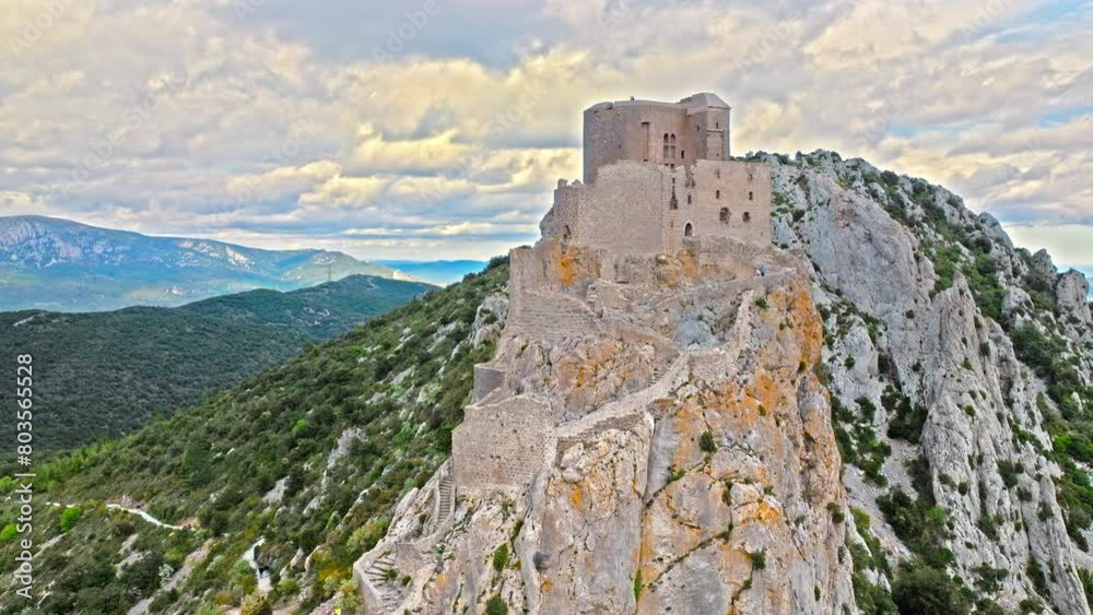 Aerial view of castle ruins perched on a craggy outcrop, with panoramic views from its tower terrace in France.
High fortress on the southern ridge of the Corbières, Château de Quéribus. Aerial view of castle ruins perched on a craggy outcrop, with panoramic views from its tower terrace in France.
High fortress on the southern ridge of the Corbières, Château de Quéribus.
