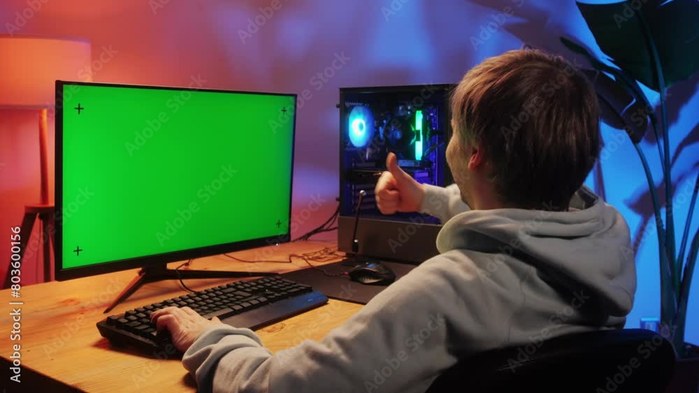 Computer with chroma key green screen on monitor. Gamer man playing in popular video games. Programmer or hacker coding a code and working in networks, cyberspace. Digital software, mobile app Computer with chroma key green screen on monitor. Gamer man playing in popular video games. Programmer or hacker coding a code and working in networks, cyberspace. Digital software, mobile app