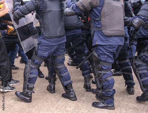 Riot police dispersed protesters and were pelted with paint. 