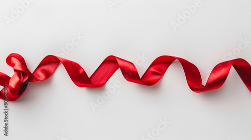 red ribbon on a red background, Red ribbon beautiful spiral rolls on a white background. Close up.